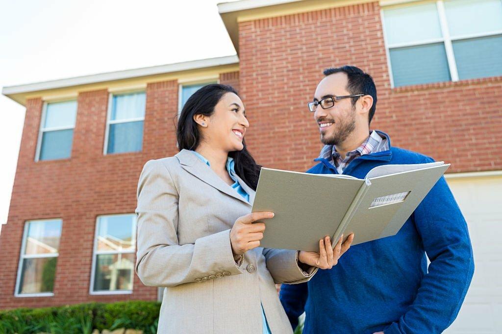 Hispanic couple deciding on choosing a professional landscaping company